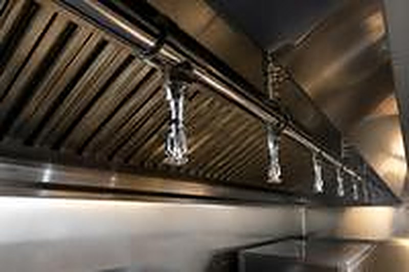 Suppression nozzles inside a kitchen hood